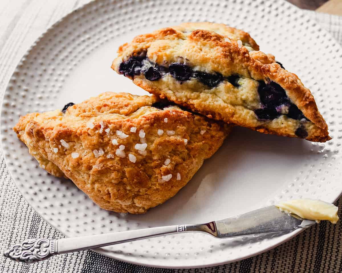 Photograph of healthy low fat scones on a white plate with a butter knife