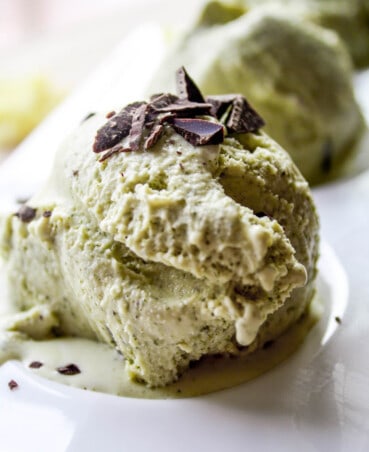 Photograph of a scoop of green tea ice cream on a white plate.
