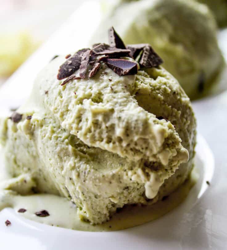 Photograph of a scoop of green tea ice cream on a white plate.