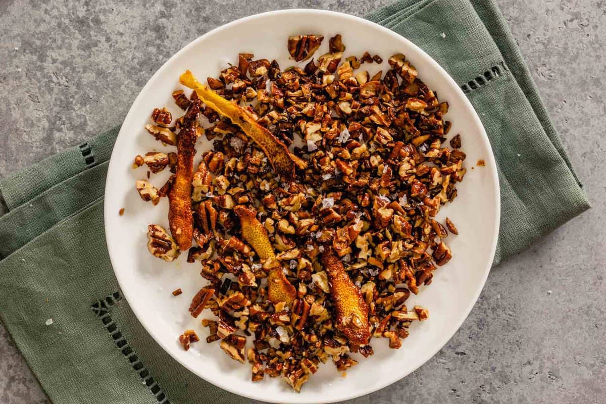 nuts, spices and lemon peels on a white plate