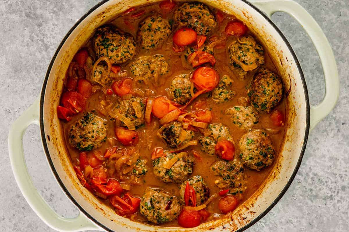 meatballs cooking in a cherry tomato sauce