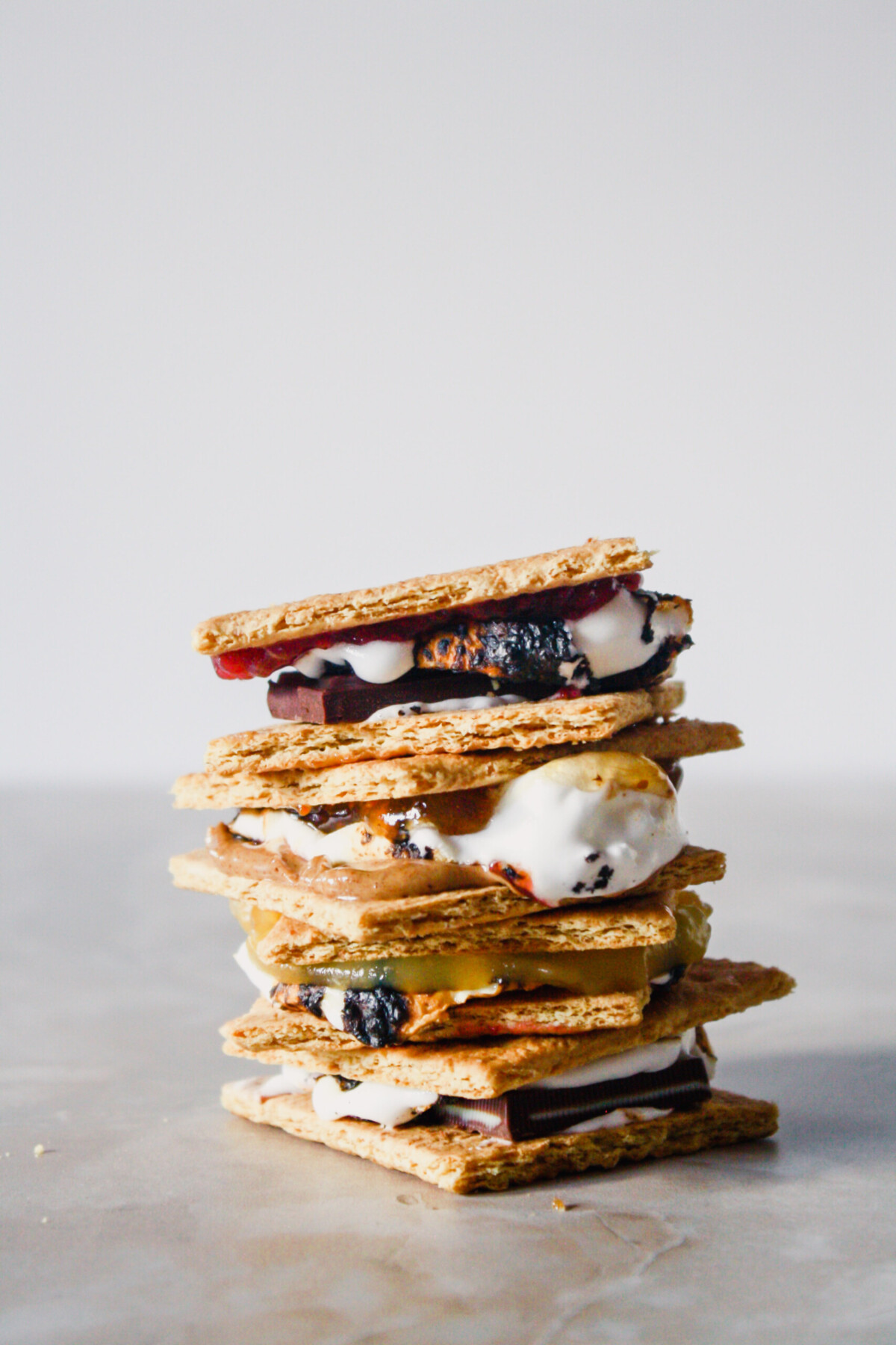 Photograph of s'mores stacked on top of each other on a marble table