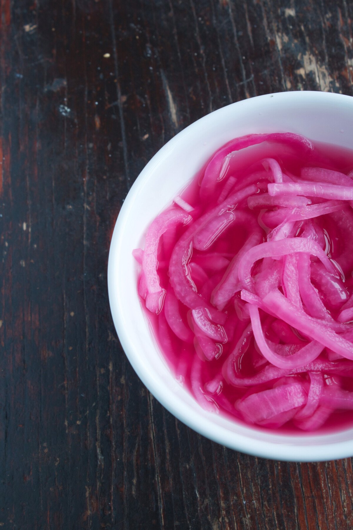 Photograph of Quick Pickled Onions in a white bowl | Zestful Kitchen