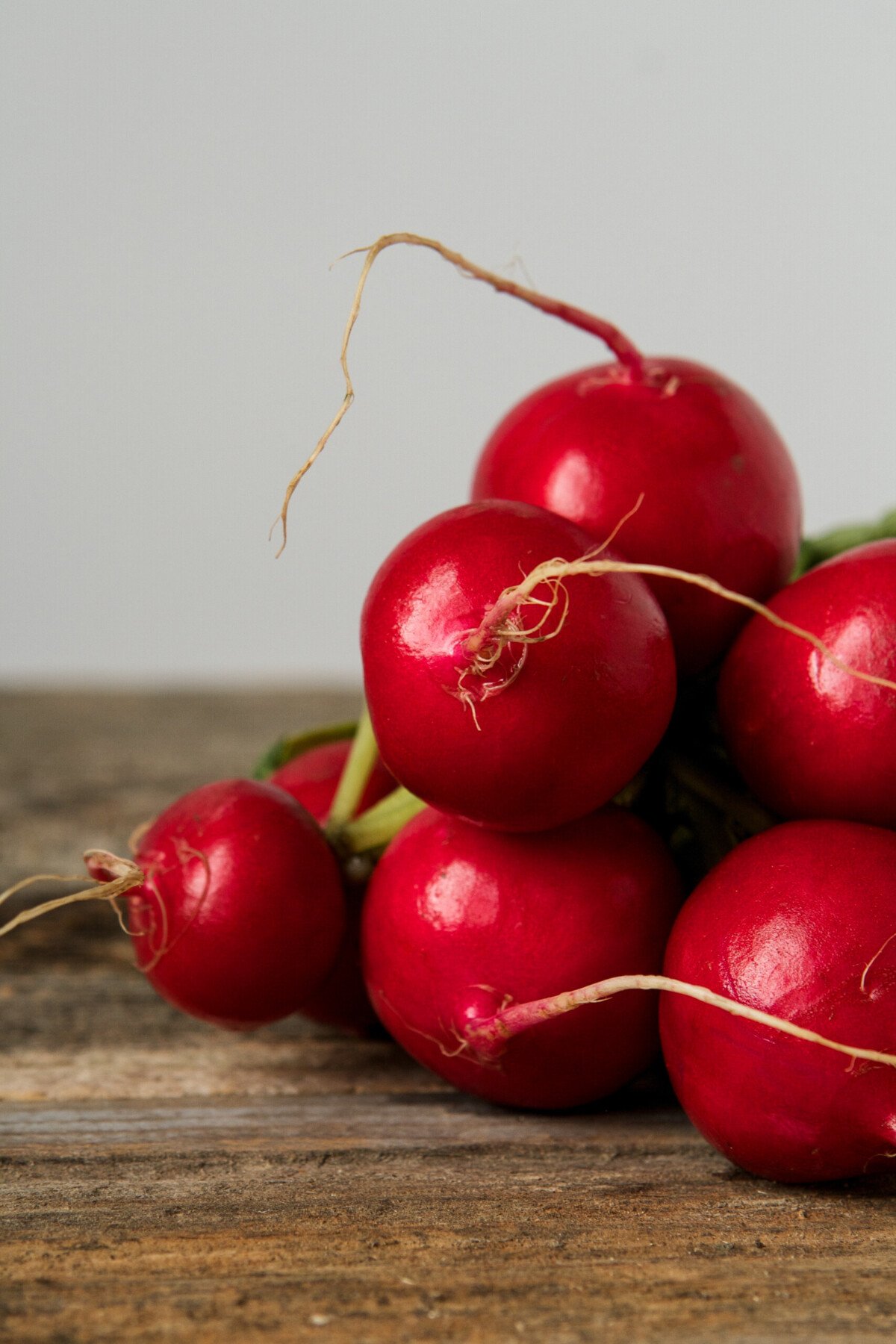 Vibrant red radishes on a wood table