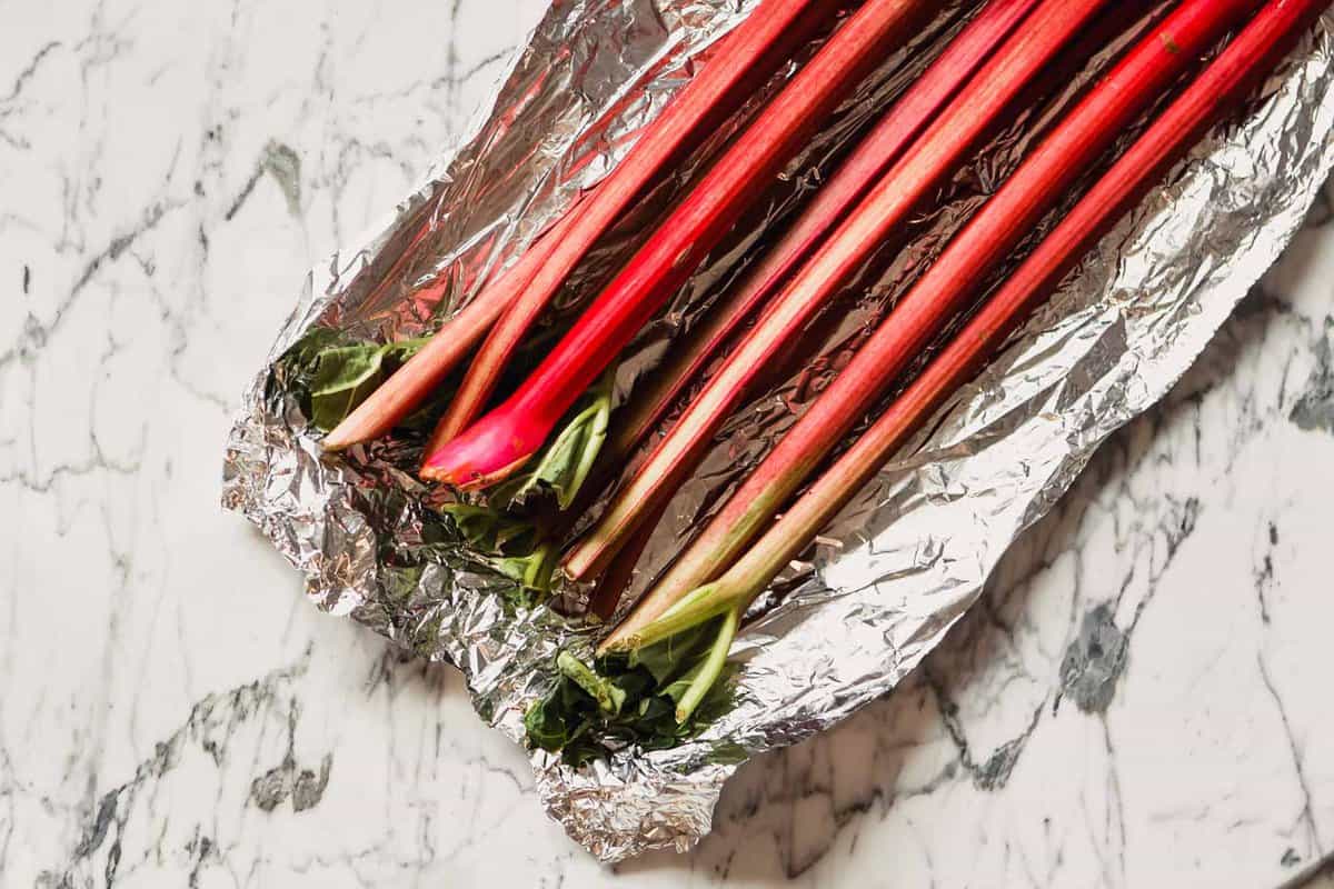 Photograph of stalks of rhubarb set in a piece of foil