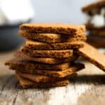 Whole wheat graham crackers stacked on a wooden table
