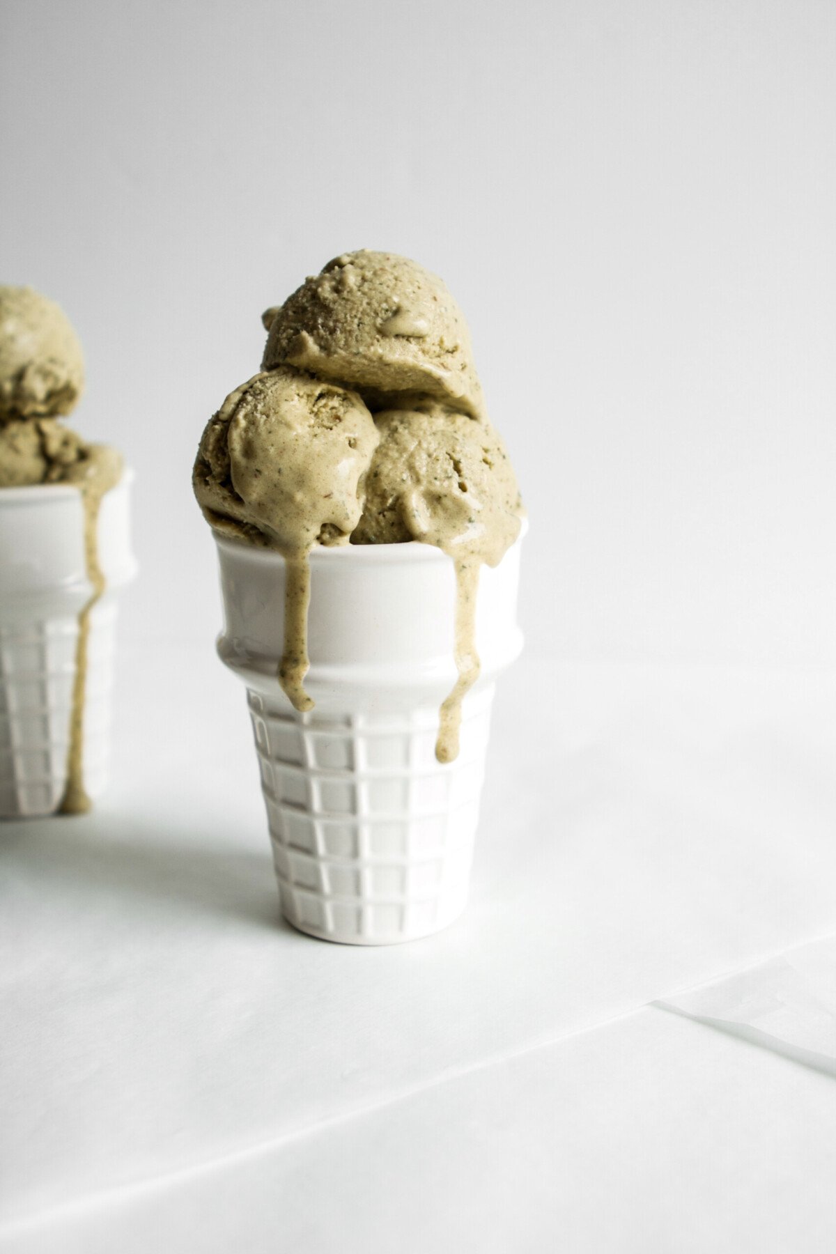 Vegan mint ice cream in a white glass cone