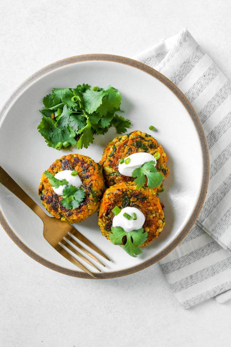 Sorghum can carrot veggie cakes set on a white plate