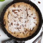 Up close photo of puffed apple pancake in cast iron skillet