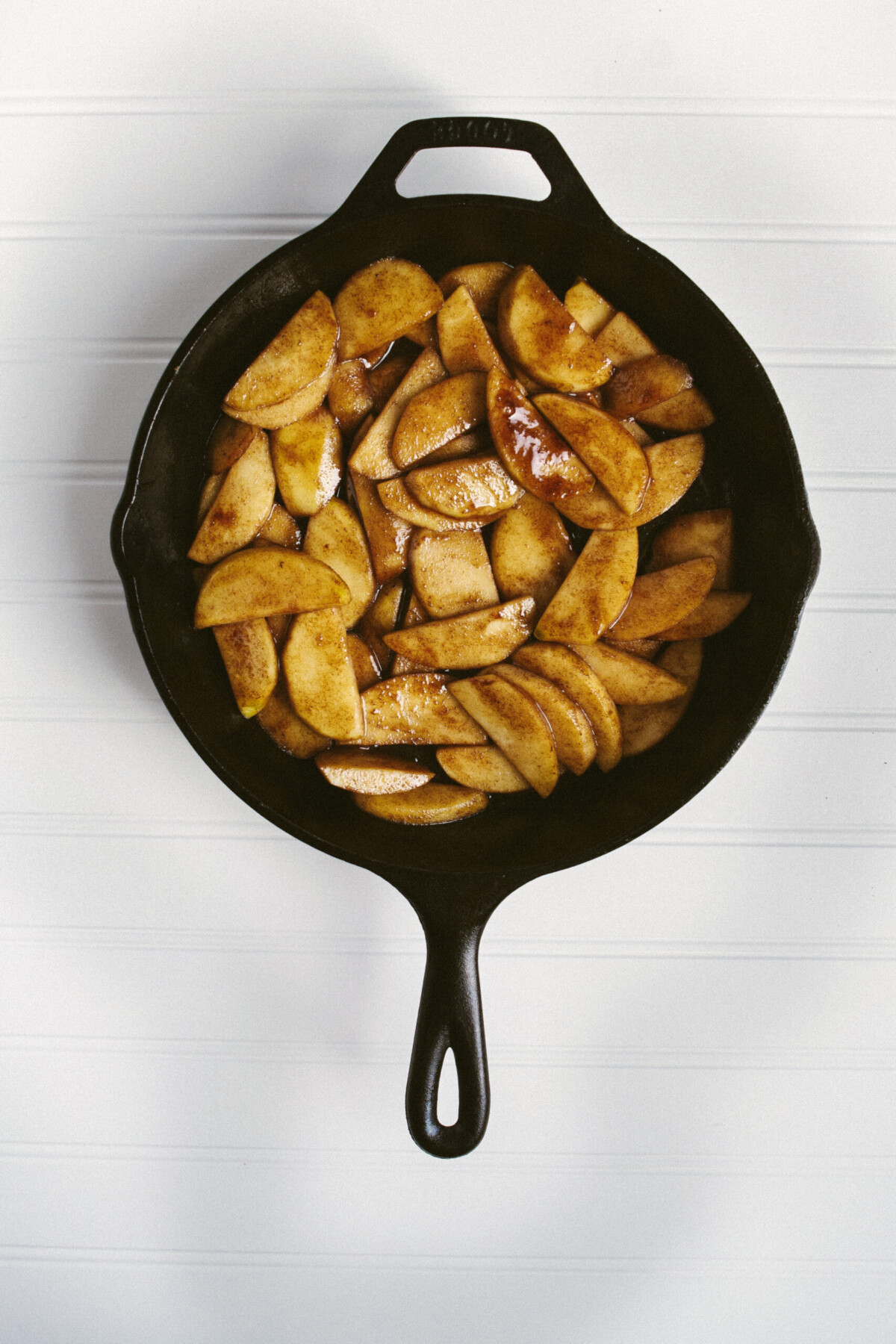 Photo of cooked apples and sugar in a cast iron skillet