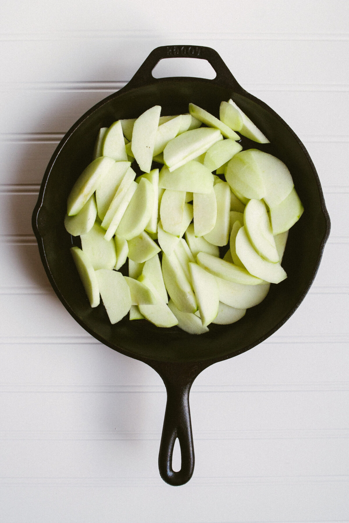 Photo of sliced apples in a cast iron skillet