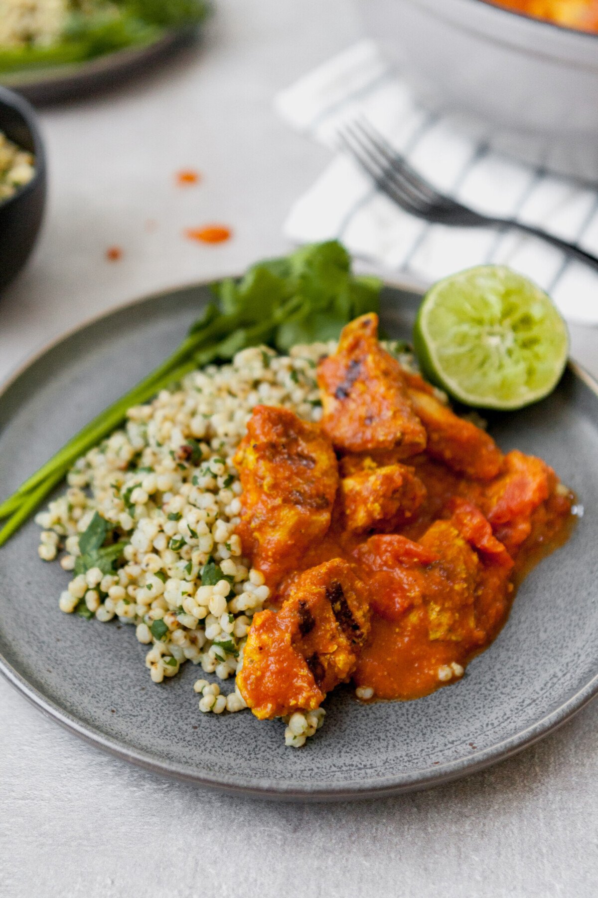 This Lightened Chicken Tikka Masala is full-flavored, healthy, and even a great make ahead meal. Atop a bed of cilantro-lime sorghum, this is classic, yet reinvented.  | from Lauren Grant of Zestful Kitchen