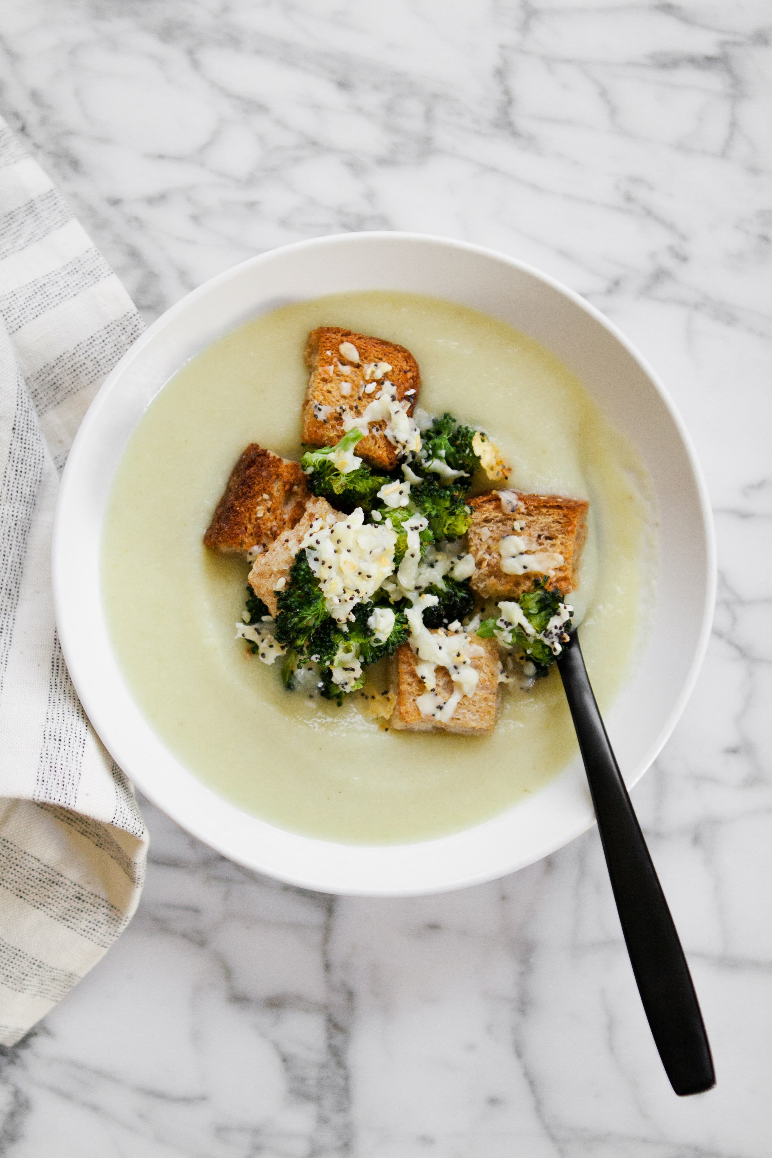 This luxurious, creamy broccoli soup is the perfect weeknight meal. Simmered and puréed broccoli stalks and potatoes offer the perfect creamy texture without making a roux or using cream. Top with cheesy “everything” spiced croutons for a meal that’s healthy, satisfying and delicious. | from Lauren Grant of Zestful Kitchen