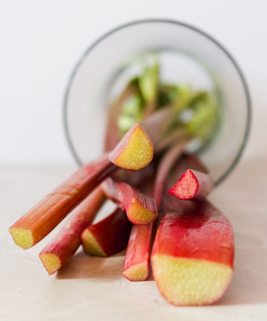 rhubarb stalks set on their side in a glass jar