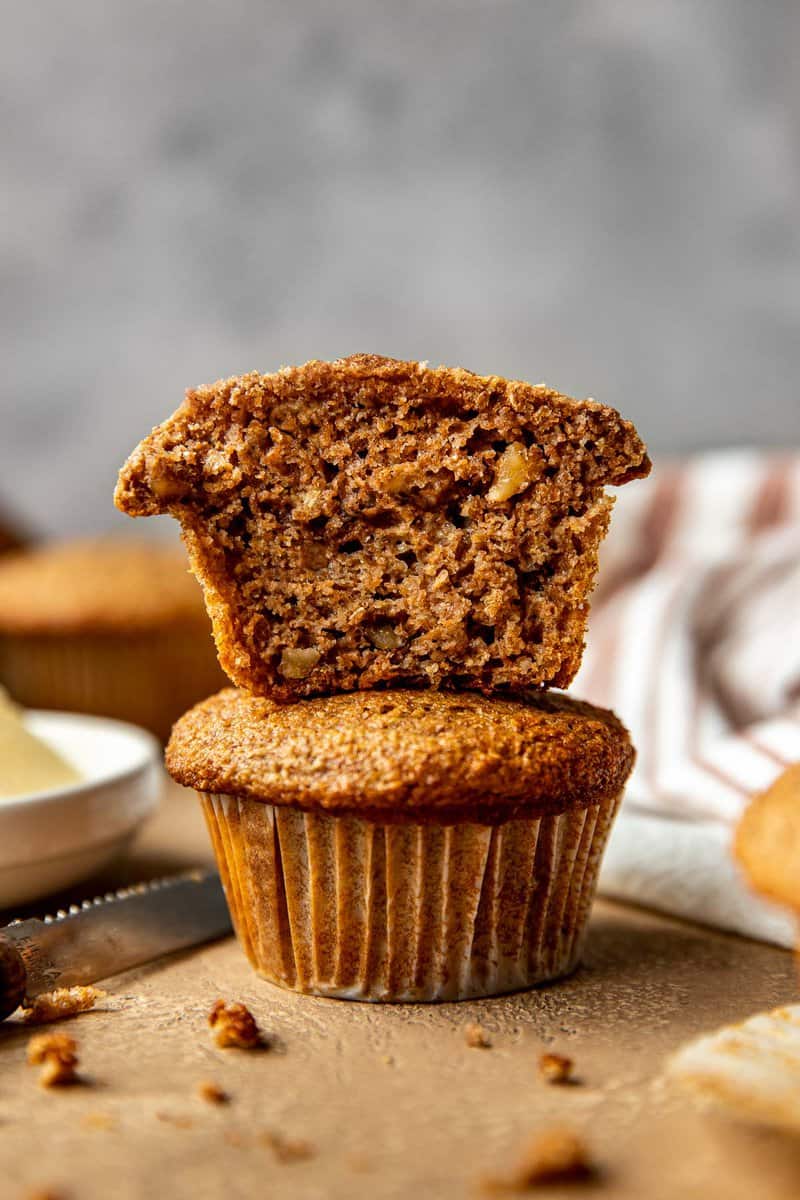 two bran muffins stacked on top of each other on a counter