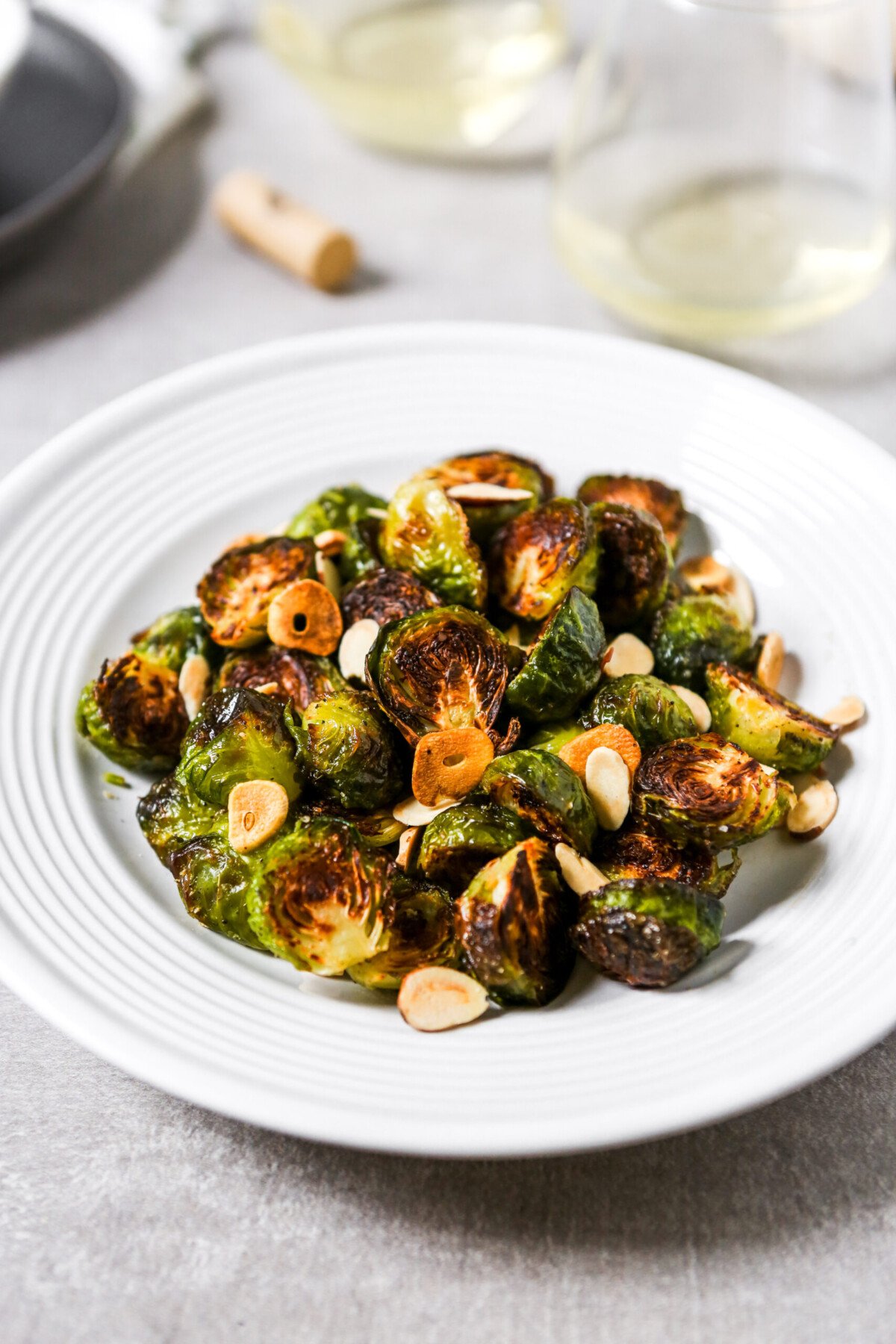 deeply roasted Brussels sprouts on a white plate. 