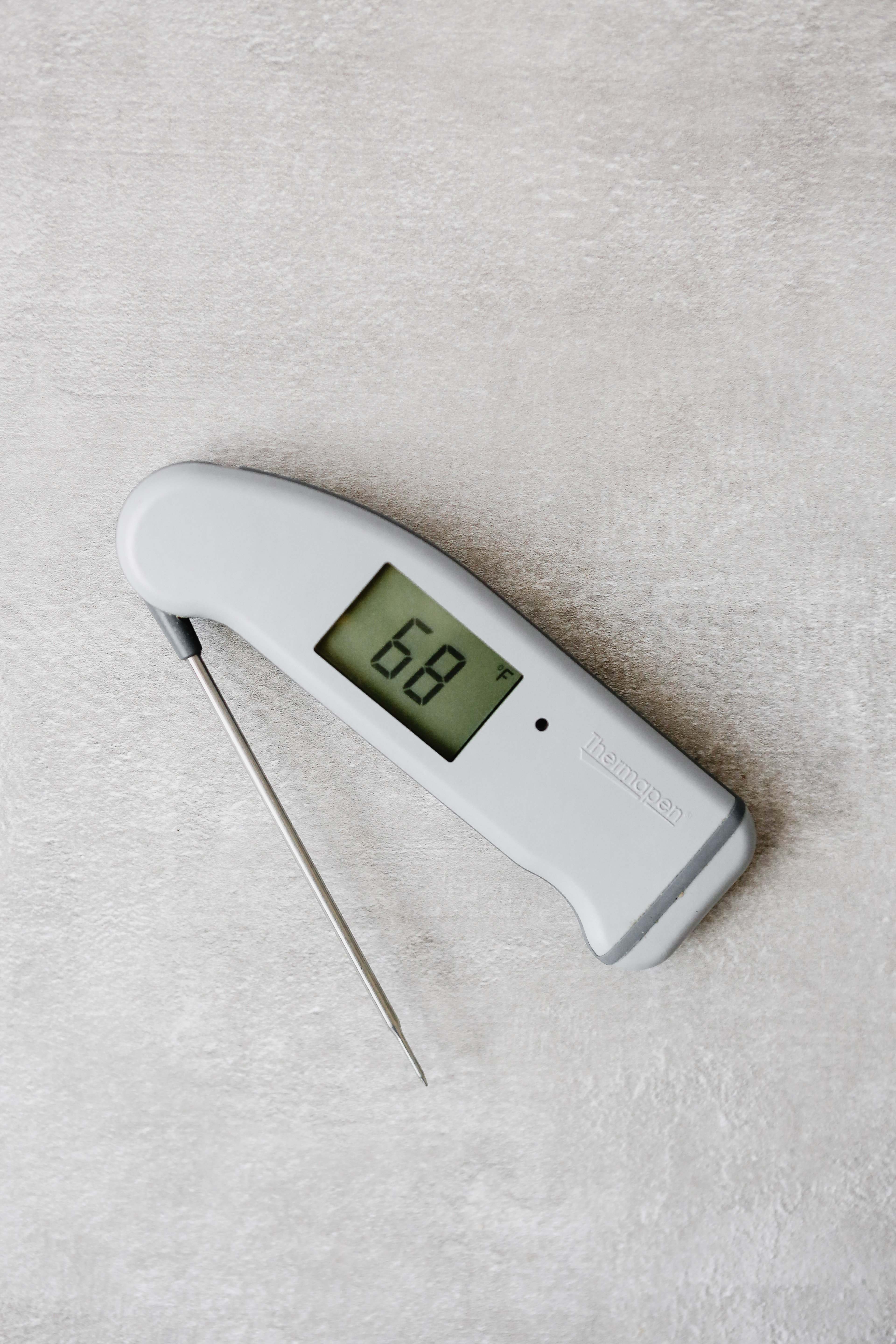 Photograph of a Thermapen thermometer on a gray table 