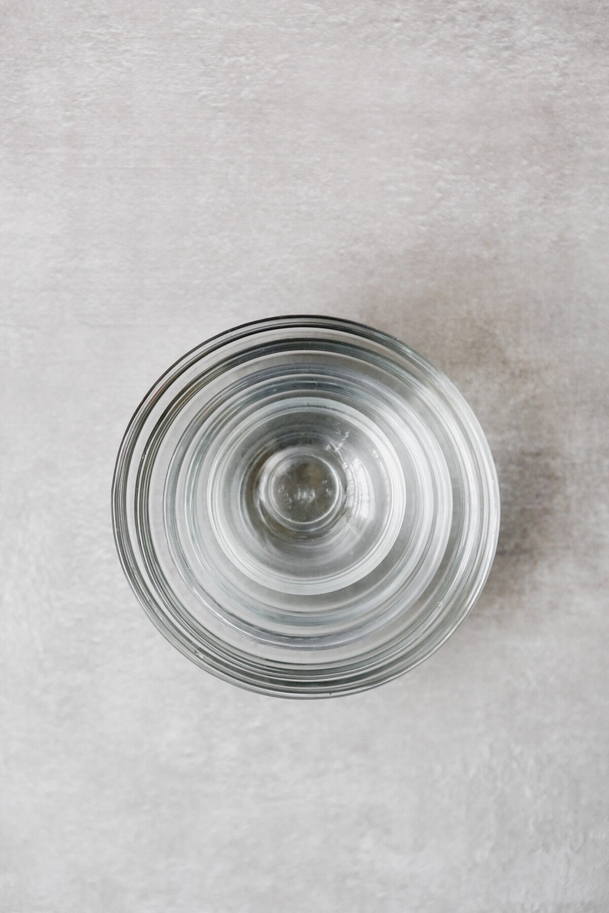 Photograph of stacked mixing bowls on a gray table 