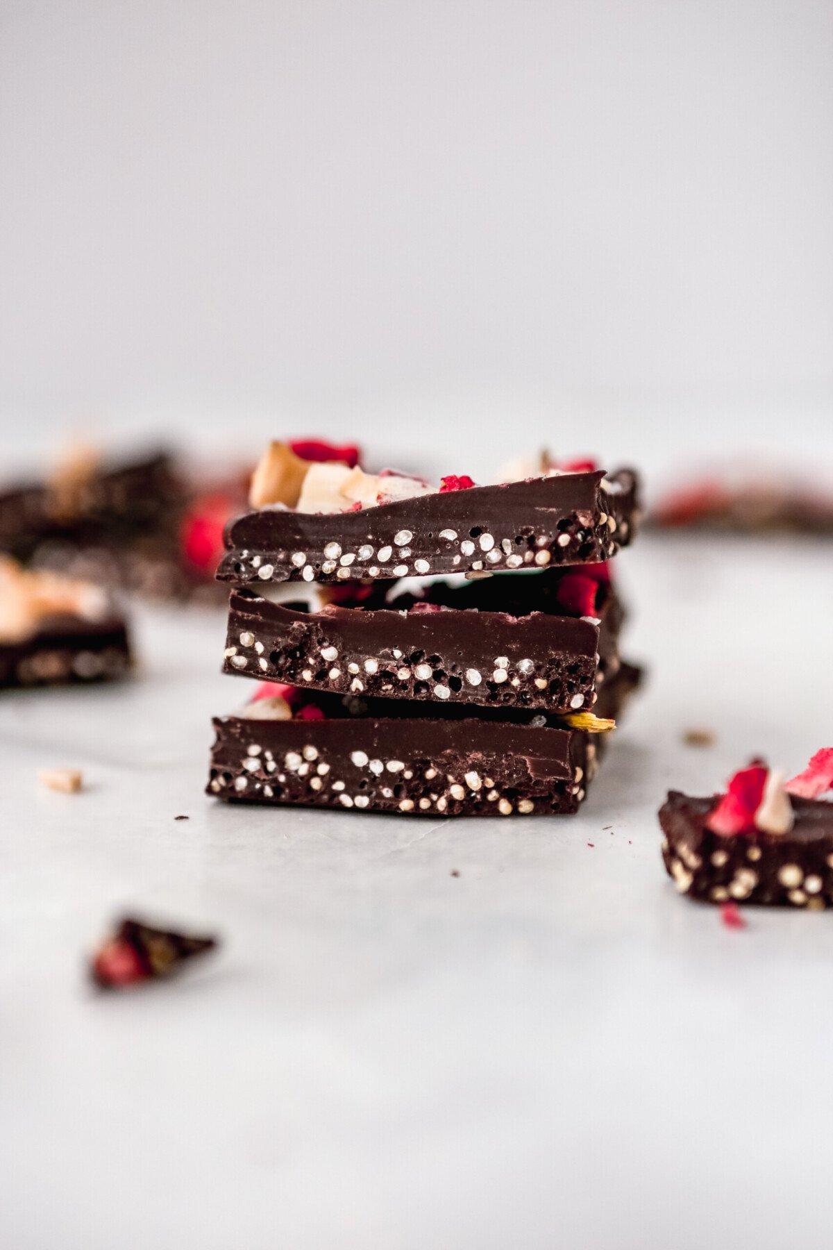 Photograph of chocolate coconut bark pieces stacked on top of each other