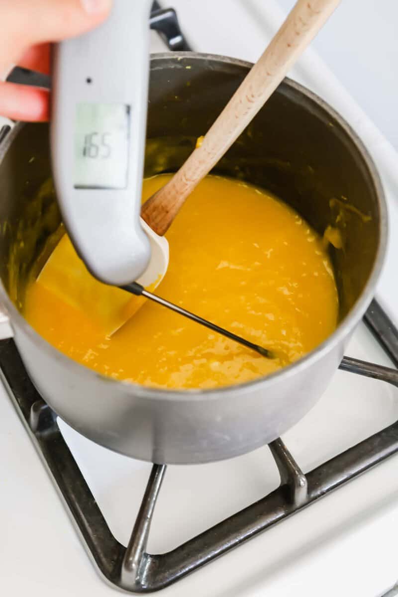 Photograph of an instant-read thermometer measuring the temperature of lemon curd being cooked