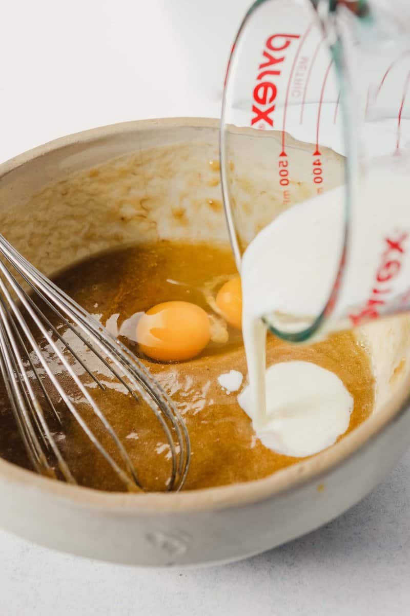 photograph of buttermilk being poured into a bowl of batter