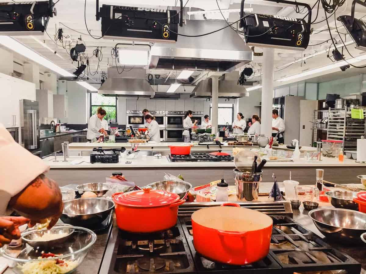 Photograph of America'sTest Kitchen with test cooks testing recipes