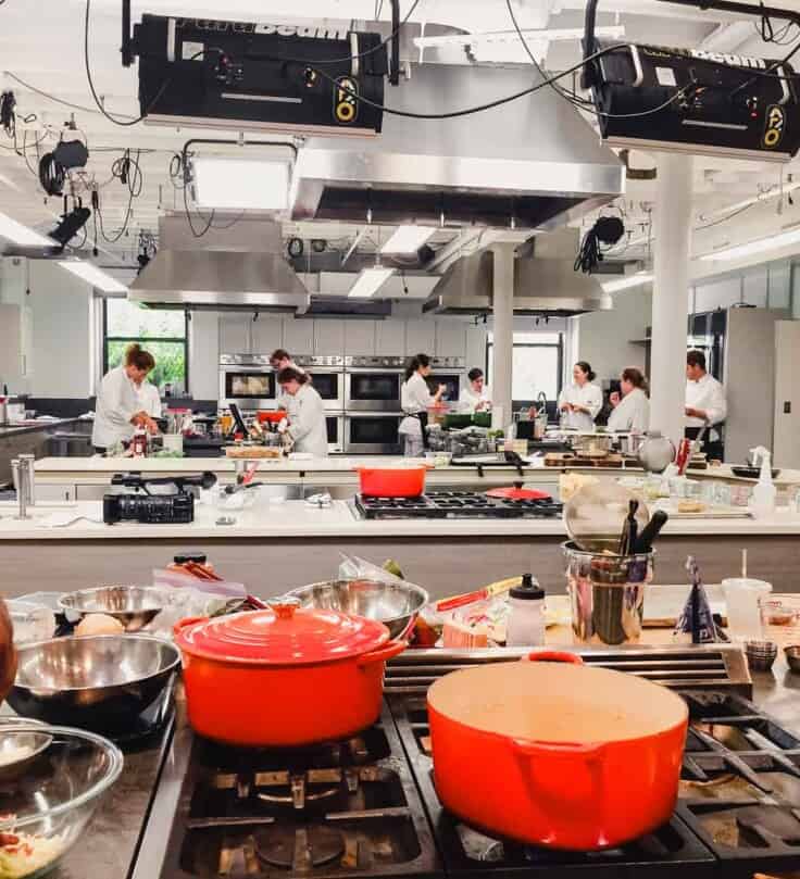 Photograph of America'sTest Kitchen with test cooks testing recipes