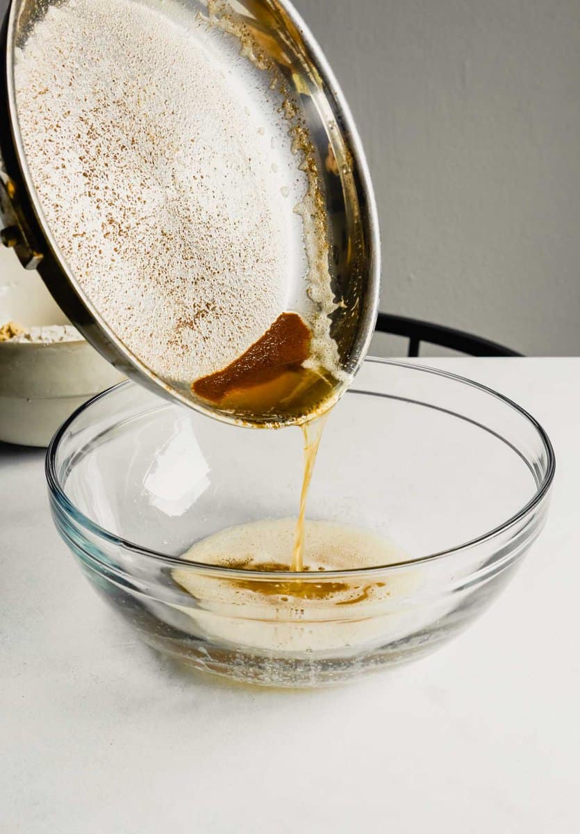 Photograph of brown butter being poured into a large glass bowl