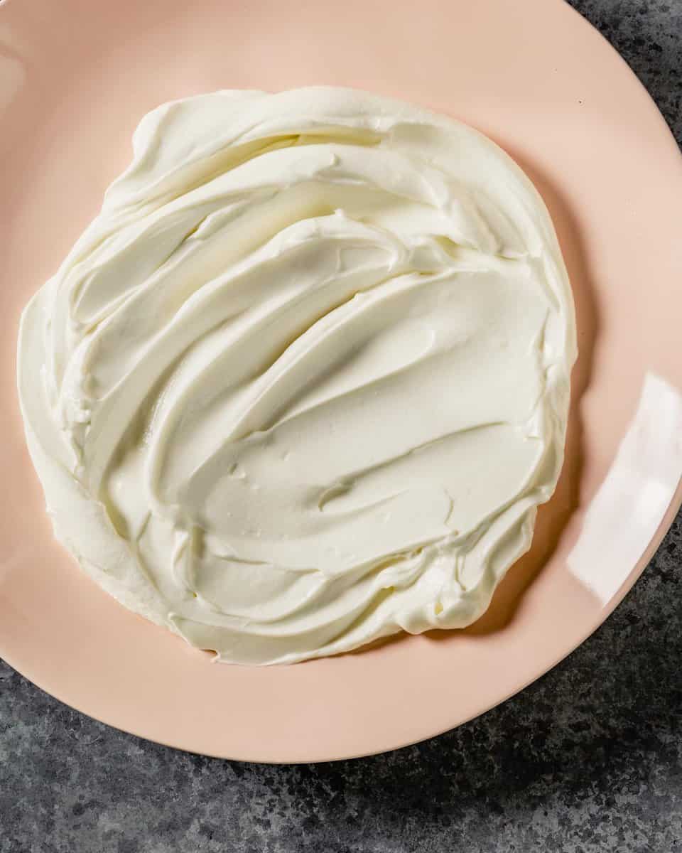 creamy white dip spread on a pink plate