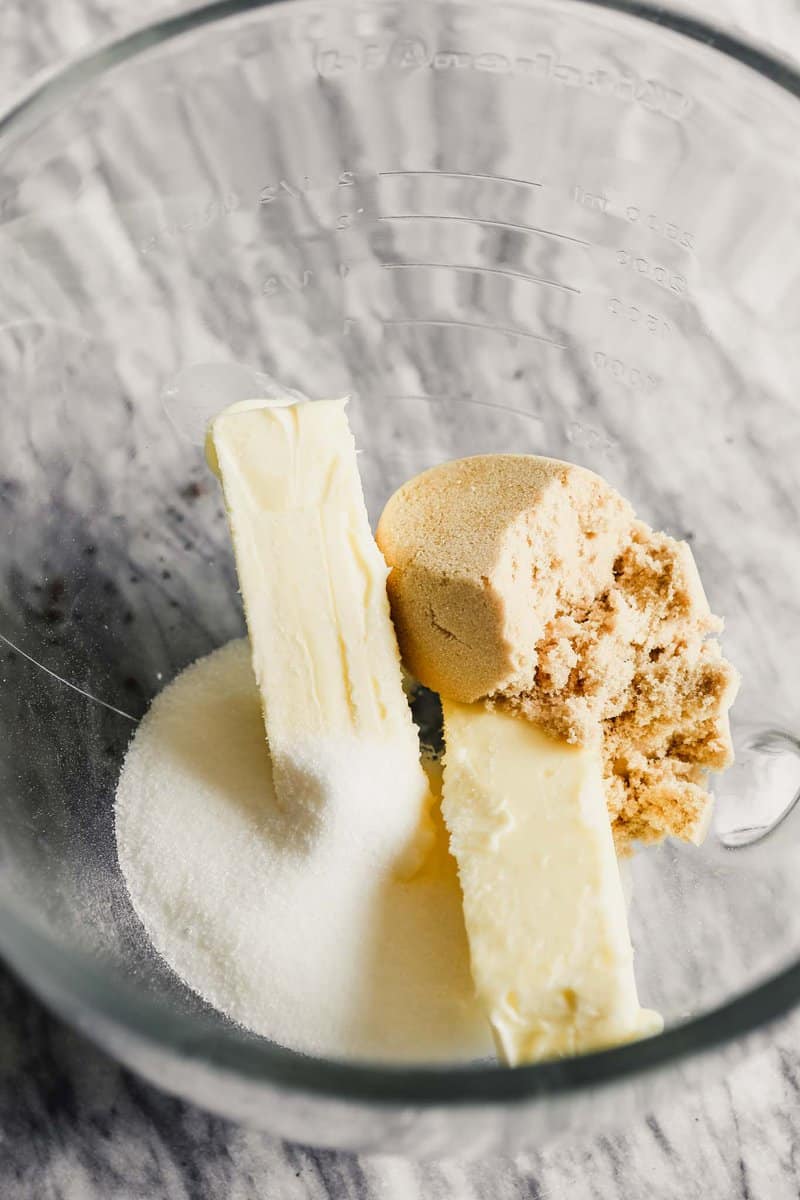Photograph of butter, sugar and brown sugar in a mixing bowl