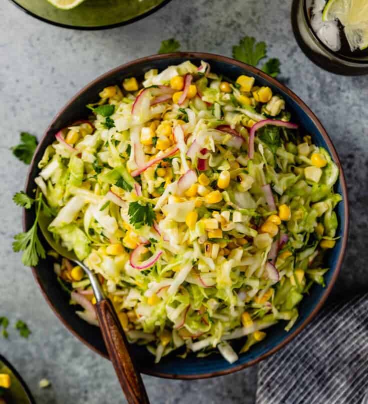 green slaw with sweet corn in a blue bowl