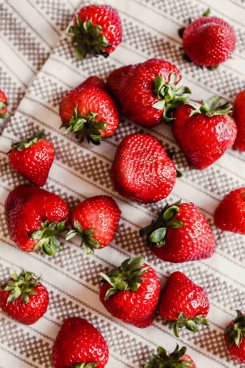 Photograph of fresh strawberries drying on a kitchen towel