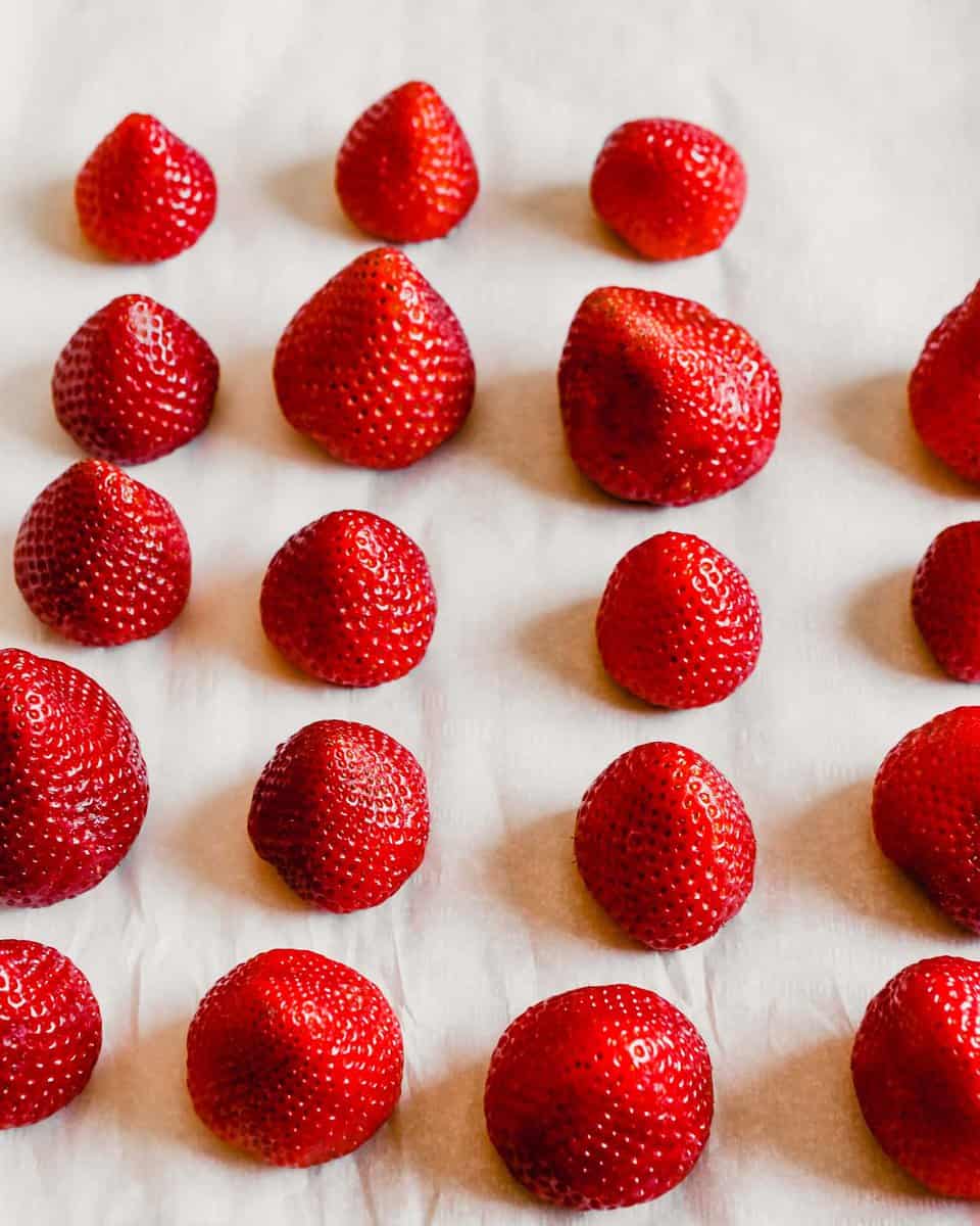 Photograph of strawberries arranged on a baking sheet