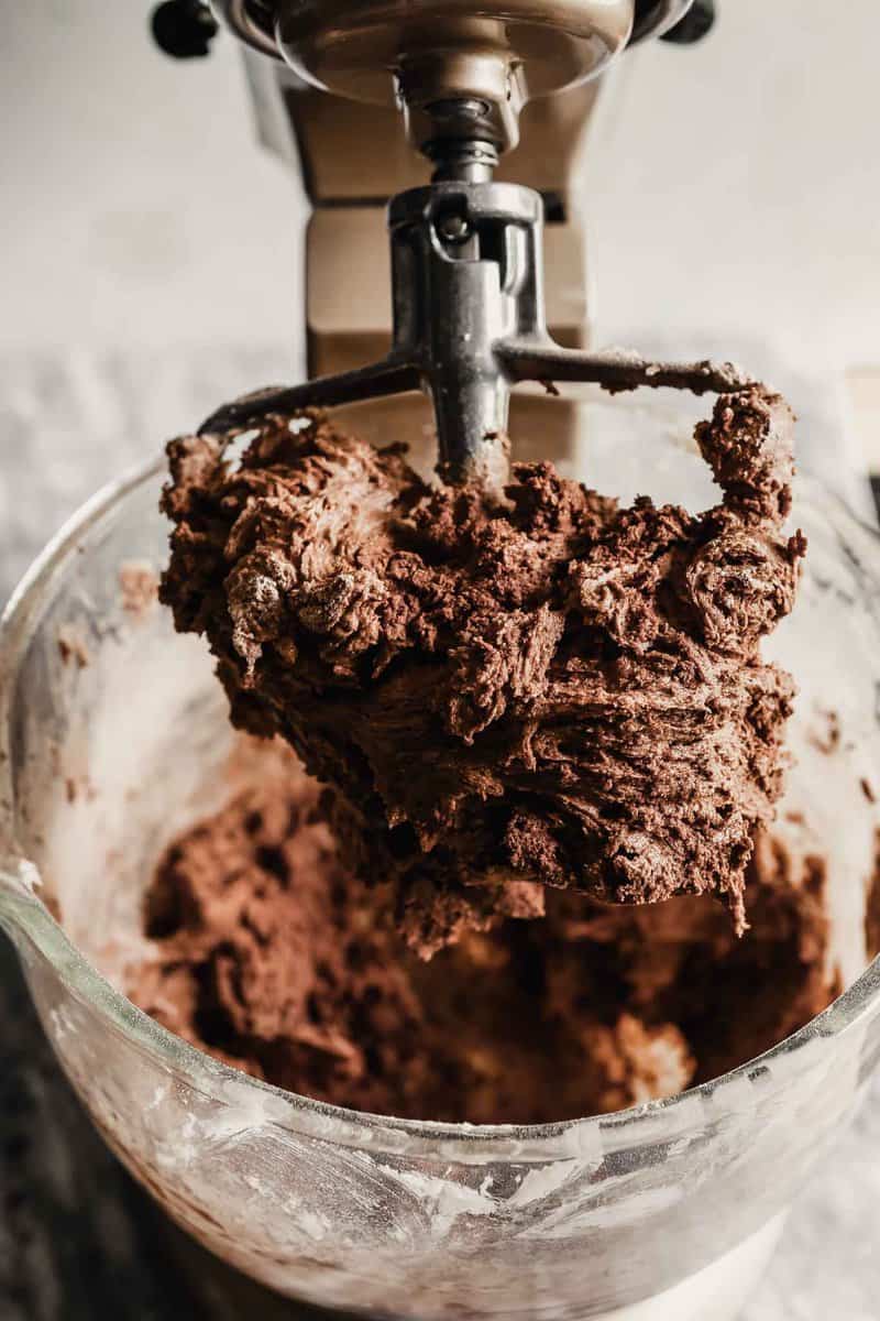 Photograph of chocolate cookie dough in a stand mixer