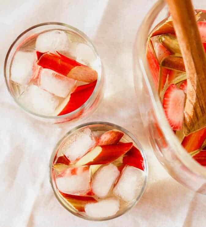 Overhead photograph of a strawberry sangria with rhubarb in glasses with ice
