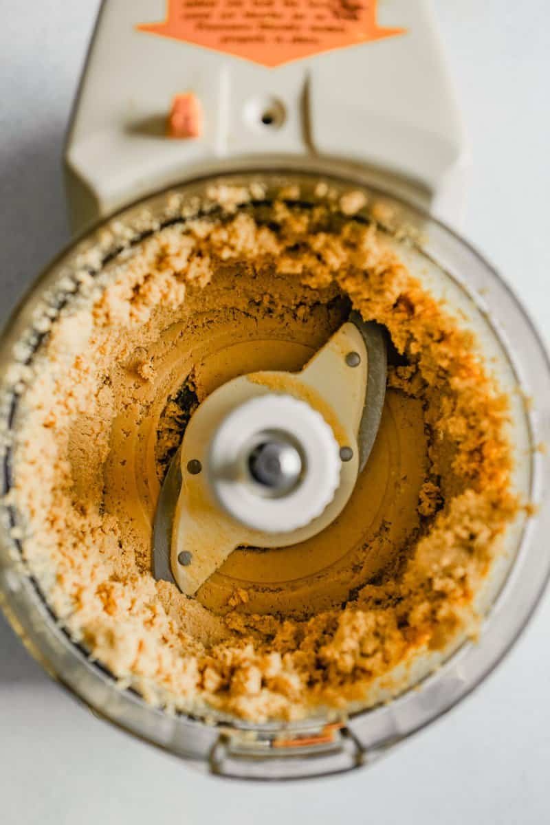 Photo of cashews being blended in a food processor to make cashew butter