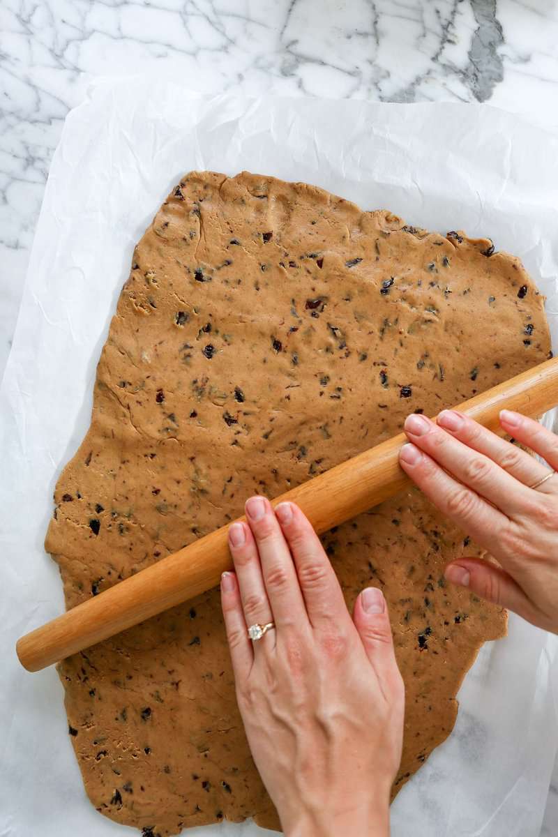 cookie dough spread onto a parchment lined baking sheet