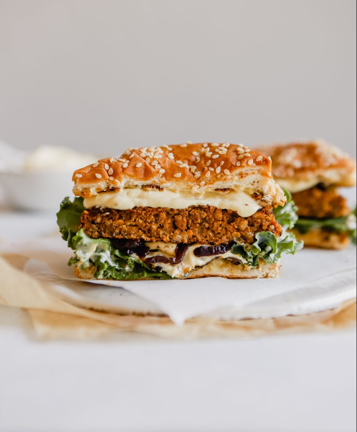 Photograph of a vegan mushroom veggie burger set on a white plate