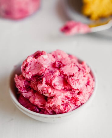 side angle of a bowl of pink-hued butter piled into it