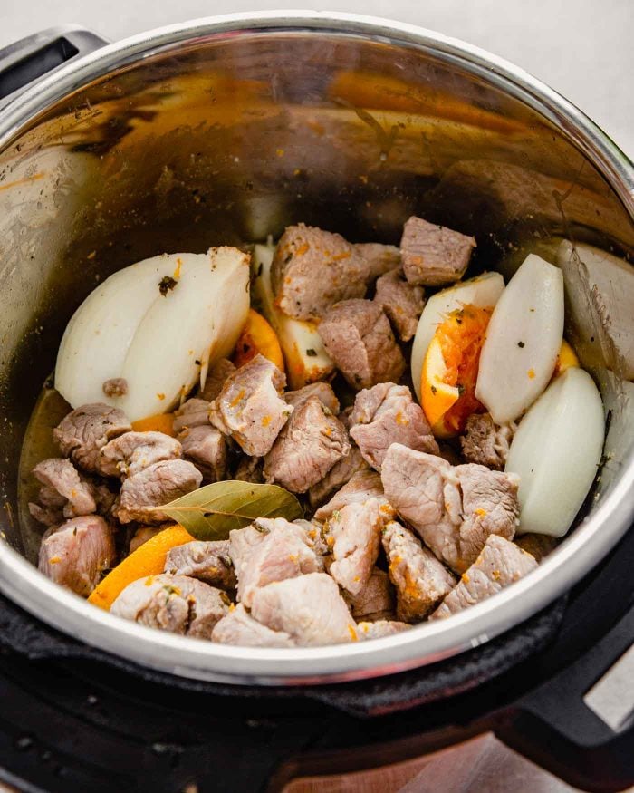 photo of seared pork with spices, onion wedges and orange halves photo of pork being seared in an Instant Pot