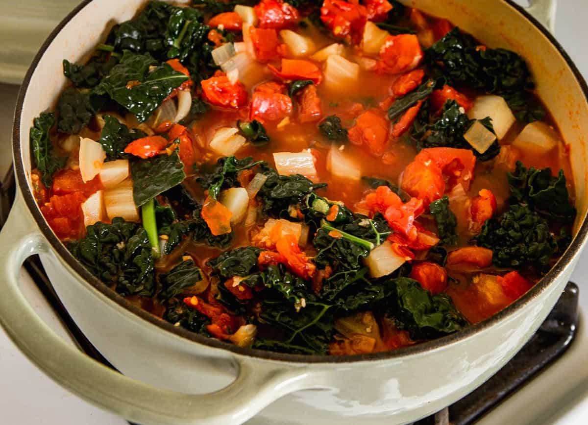tomato and kale soup in a Dutch oven