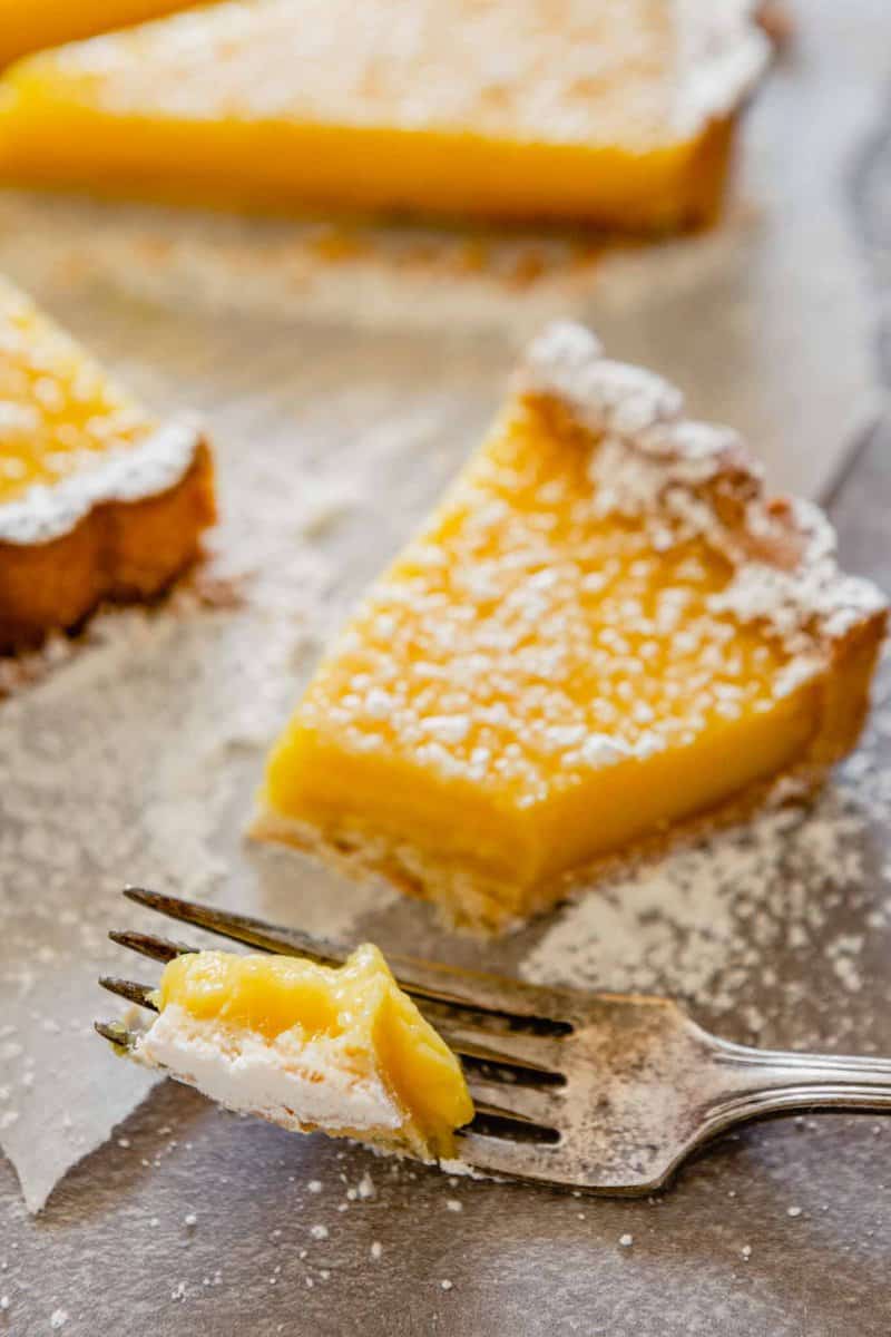 close up image of a bite of lemon tart on a fork