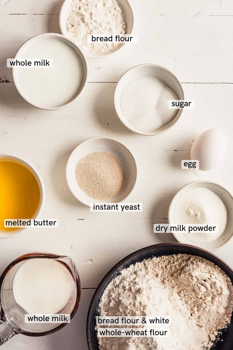 Overhead image of milk bread ingredients on a white table