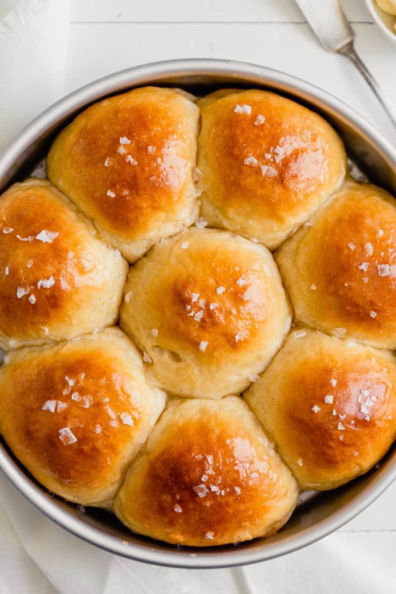 Full batch of milk buns baked in a round pan.