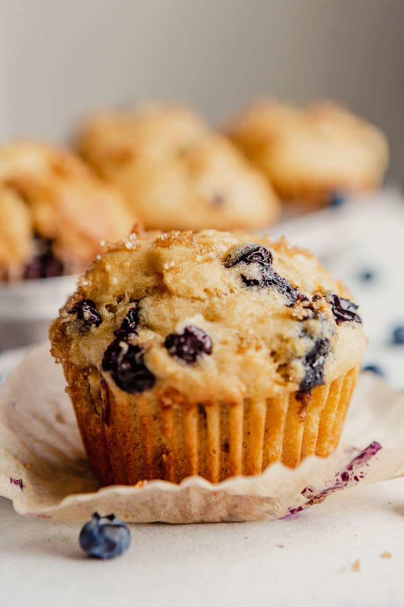 A blueberry muffin set on a countertop.