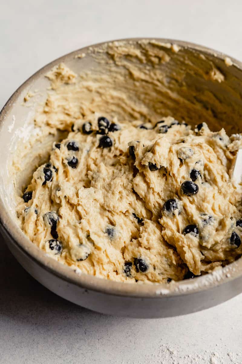 Healthy blueberry muffin batter in a stone mixing bowl.