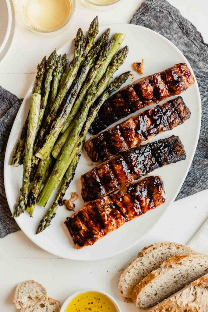 glazed salmon fillets on a plate with grilled asparagus 