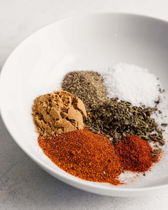 spices measured out in a white bowl