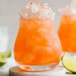 orange cocktail in a rocks glass filled with crushed ice
