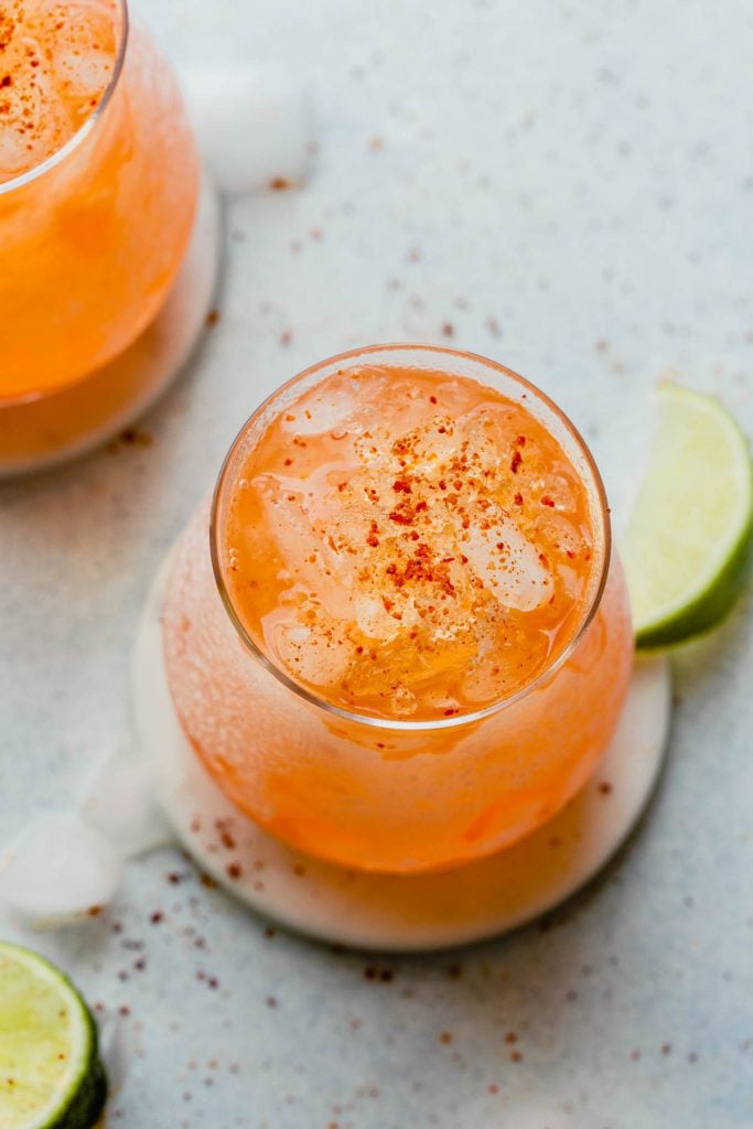 orange-colored aperol margarita cocktail in a rocks glass filled with crushed ice